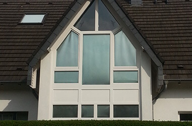 Privathaus mit Giebelförmigem Fenster, beschattet mit Multifilm Rollos - Blick von außen